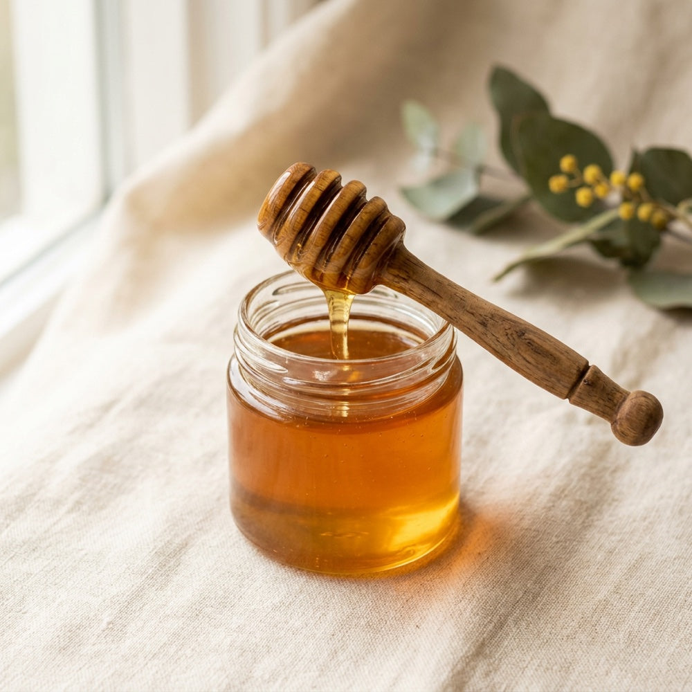 Australian honey in a jar with a wooden dipper
