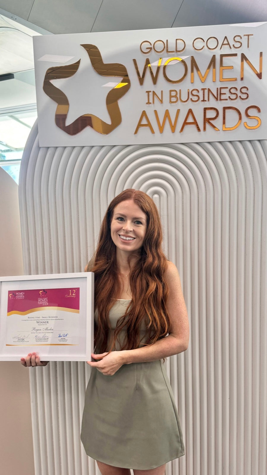 Regan Merka holding her Gold Coast Women in Business Awards 2024 Rising Star certificate