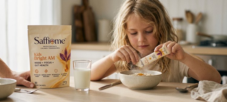A girl squeezing a Bright AM honey sachet onto her porridge at the breakfast table, her mum beside her and the Bright AM pouch by the milk